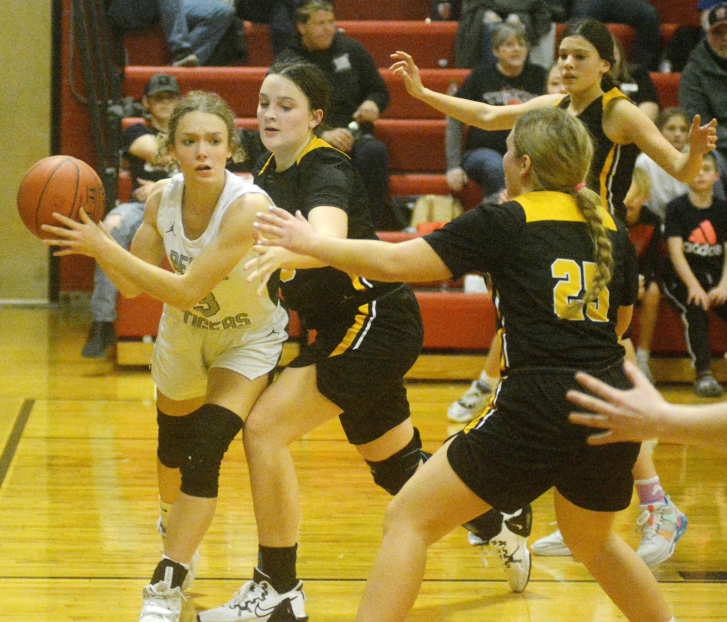 Hali Naber (far left) looks for someone to pass the ball to while being double teamed by Vienna’s Aubrey Schwartze and Marissa Hollis during Battle of Maries County girls basketball action at Belle High School.